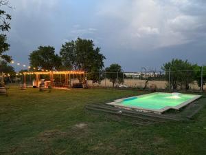 a swimming pool in a yard with a fence at Finca Alboroto in Huesca