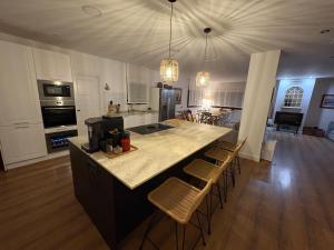 a kitchen with a large island in the middle of a room at Finca Alboroto in Huesca