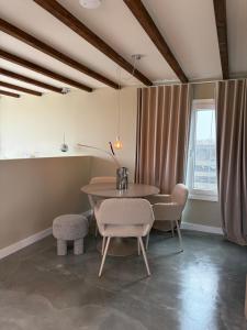 a dining room with a table and chairs and a window at Studio34 in Hauwert +41 photos
