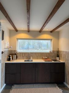 a kitchen with a sink and a window at Studio34 in Hauwert