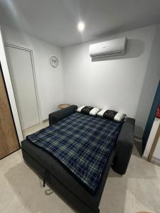 a room with a bed in a room with a fan at Studio 2 personnes maximum in Saint-Andiol