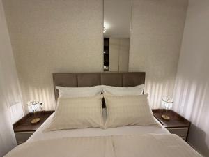 a large bed with white sheets and pillows at Stelmar Apartment in Banja Luka