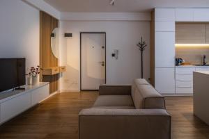 a living room with a couch and a kitchen at Mirror Apartments in Satu Mare +9 photos