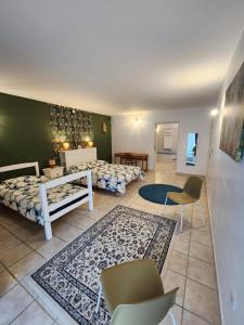 a bedroom with two beds and a table and chairs at Moulin de Montizeau in Saint-Maigrin +52 photos
