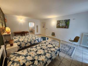 a bedroom with two beds and a table and chairs at Moulin de Montizeau in Saint-Maigrin