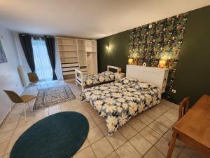 a bedroom with two beds and a table and a dining room at Moulin de Montizeau in Saint-Maigrin