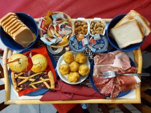 a tray of food with different types of breakfast foods at B&B Nonna Assunta in Collegiove +14 photos