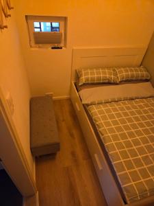 a small bedroom with a bed and a window at Ferienwohnung Noltenius 2 in Bülstedt