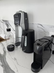 a counter top with a coffee maker and other appliances at La suite du parc 2 in Nancy +24 photos
