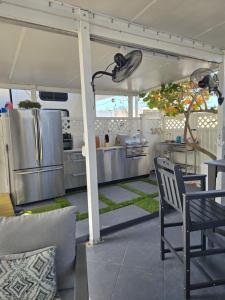 an outdoor kitchen with a table and chairs at Marina View Cottage at Key Largo in Key Largo