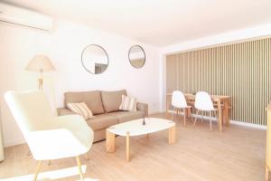 a living room with a couch and chairs and a table at Wohnung Rio in Calpe