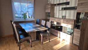 a dining room with a wooden table and chairs at Haus Ferien Bock in Clausthal-Zellerfeld