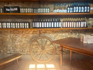 a wooden cart sitting next to a stone wall at Podere Casato in Montespertoli