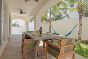 a dining room with a table and chairs and palm trees at Experience Luxury on Isla Mujeres! in Isla Mujeres