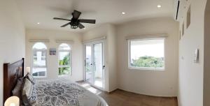 a bedroom with a bed and a ceiling fan at Experience Luxury on Isla Mujeres! in Isla Mujeres +24 photos