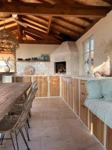 a kitchen with wooden cabinets and a table and chairs at Châtel de Bierre in Sigy-le-Châtel