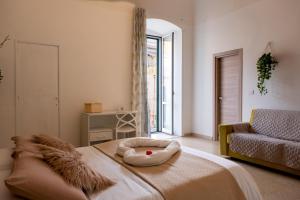 a room with a bed with a stuffed animal on it at Le Gravinelle - Apulia Houses & Flats in Ruvo di Puglia