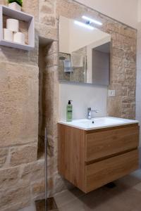 a bathroom with a sink and a mirror at Le Gravinelle - Apulia Houses & Flats in Ruvo di Puglia +94 photos
