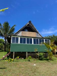 a house with a green and white at Hare Sunset Rapa Nui in Hanga Roa +15 photos
