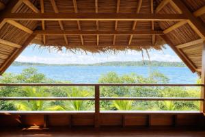 a view from the porch of a resort overlooking the ocean at Akwaba Lodge Island Boutique Hotel in The Gap