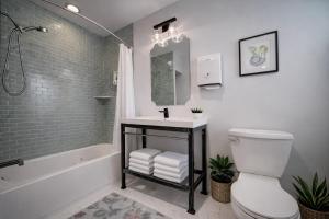 a bathroom with a sink and a toilet and a tub at Artsy Hidden Gem --- FREE PARKING in Philadelphia