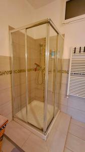 a shower with a glass enclosure in a bathroom at La Casa di Anastasya in Castiglione Torinese +32 photos