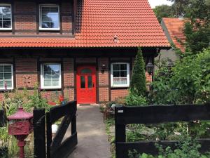 a red door on a red brick house at Welsh Dragon in Siedlung Schönwalde