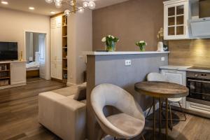 a kitchen and living room with a couch and a table at Apartament de lux central in Satu Mare