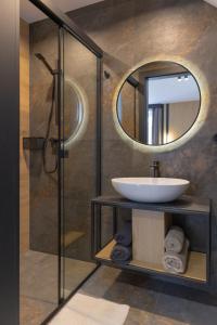 a bathroom with a sink and a mirror at Apart M in Krynica Zdrój