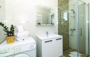 a white bathroom with a sink and a shower at Apartments KIDS in Kaštela +38 photos