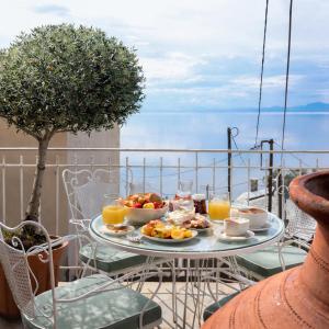 a tray of food on a table on a balcony at Vista Mare 2 in Afissos