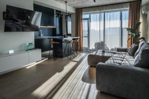 a living room with a couch and a table at Luxury Blue Apartment in Satu Mare