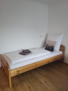 a bed in a room with white sheets and pillows at Ferienwohnung Pöll in Stanz bei Landeck