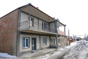 a building with a balcony on the side of it at Myasnikyan Suites in Gyumri