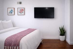 a bedroom with a bed and a flat screen tv on the wall at Artsy Hidden Gem -- FREE PARKING in Philadelphia