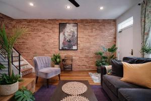 a living room with a brick wall at Artsy Hidden Gem -- FREE PARKING in Philadelphia