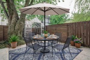 a table and chairs with an umbrella on a patio at Artsy Hidden Gem -- FREE PARKING in Philadelphia