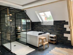 a bathroom with a tub and a glass shower at Cocon de Fontaine in La Madeleine-de-Nonancourt +26 photos