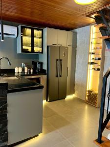 a kitchen with a stainless steel refrigerator in a room at Cabana Espelho da Lua in Itá