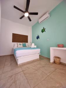 a bedroom with a bed with a ceiling fan at blue BOCANA in Santa Cruz Huatulco