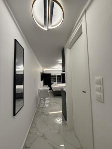 a hallway with a room with a bed and a chandelier at City Center Lux Studio in Athens
