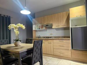 a kitchen with a wooden table and a refrigerator at Nueva Vizcaya & Suites in Hidalgo del Parral +15 photos