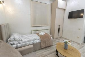 a small room with a bed and a table at Myasnikyan Suites in Gyumri