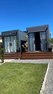 a house with a deck with potted plants on it at Studio 02 Container Aeroporto in Florianópolis
