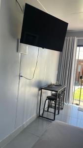 a black table and chairs in a room at Studio 02 Container Aeroporto in Florianópolis +4 photos