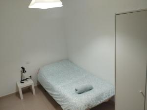 a bedroom with a bed with a pillow on it at Apartamentos calatorao con jardín y 3 habitaciones in Calatorao