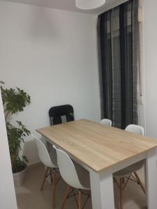 a wooden table and chairs in a room at Apartamentos calatorao con jardín y 3 habitaciones in Calatorao +6 photos