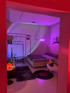 a room with a bed and a purple light at استوديو مميز بأثاث مريح in Al Khobar