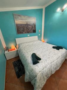 a bedroom with a large bed with a blue wall at Casa PerlAmbra Abruzzo in Casagreca