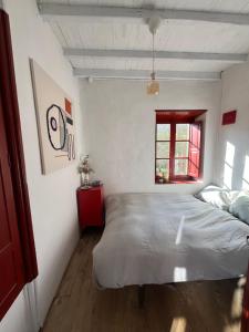 a bedroom with a large bed and a window at Cal Mengo in La Vega